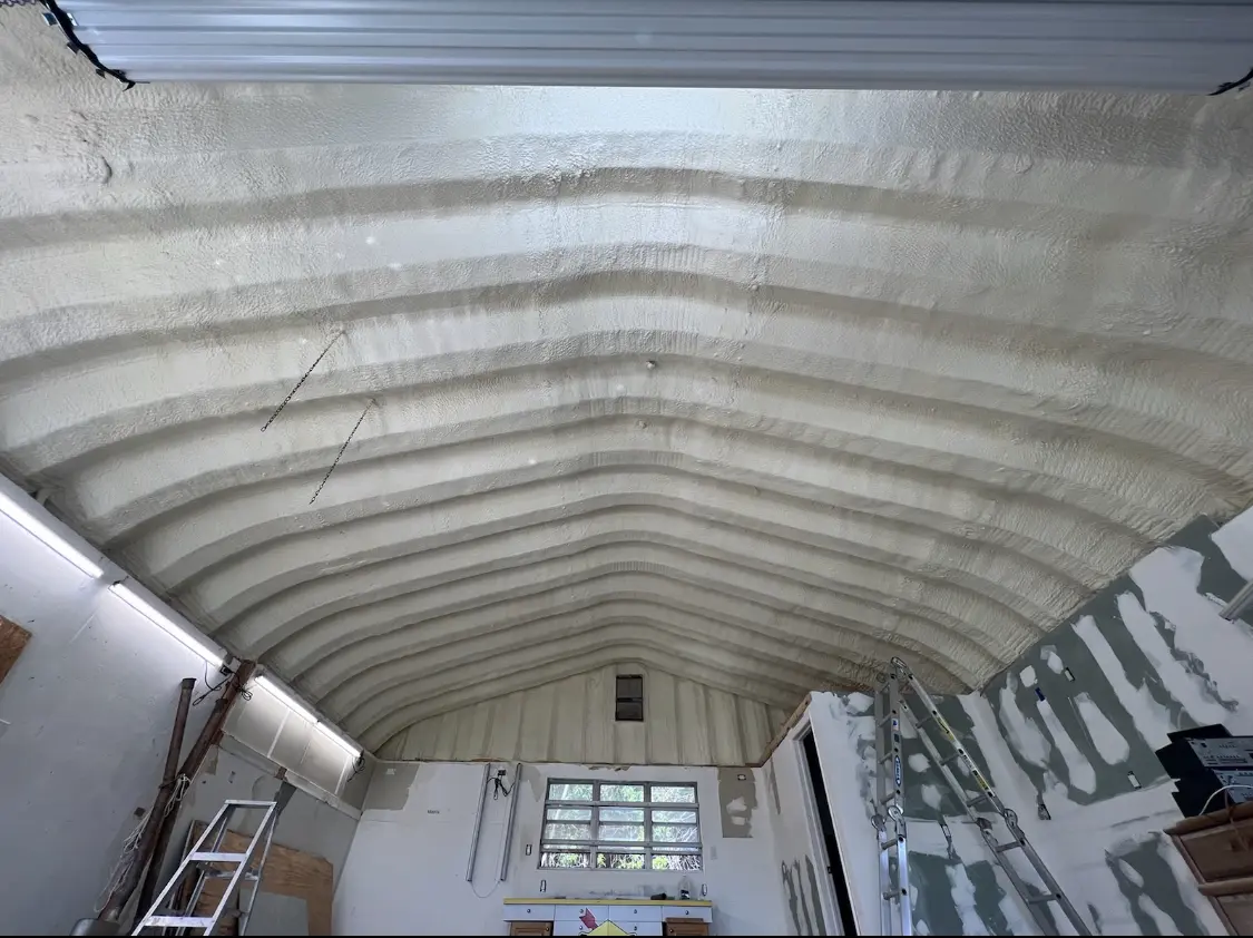 Spray polyurethane foam applied to the underside of a metal roof deck in Pace